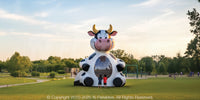24-foot inflatable Cow Bouncer™ with children for scale