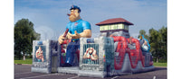 Angled view of the Alcatraz obstacle course cartoon prison with cartoon guard and inmate characters.