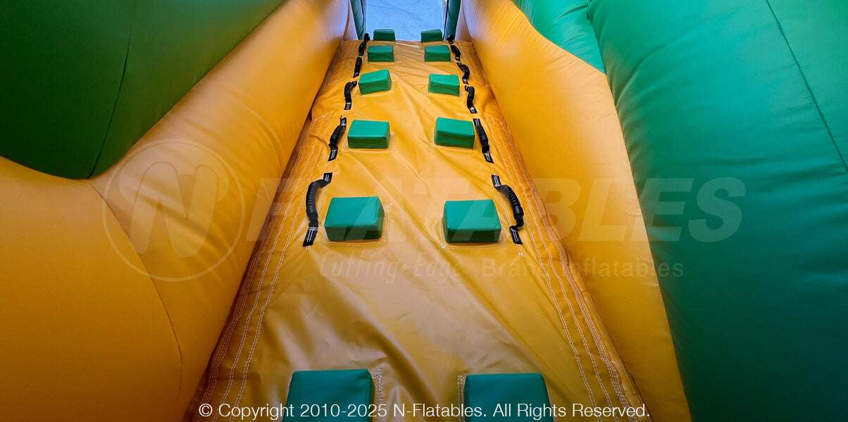 Large climbing ramp on the Barnyard Breakout dual 180 obstacle course with yellow and green colors. 