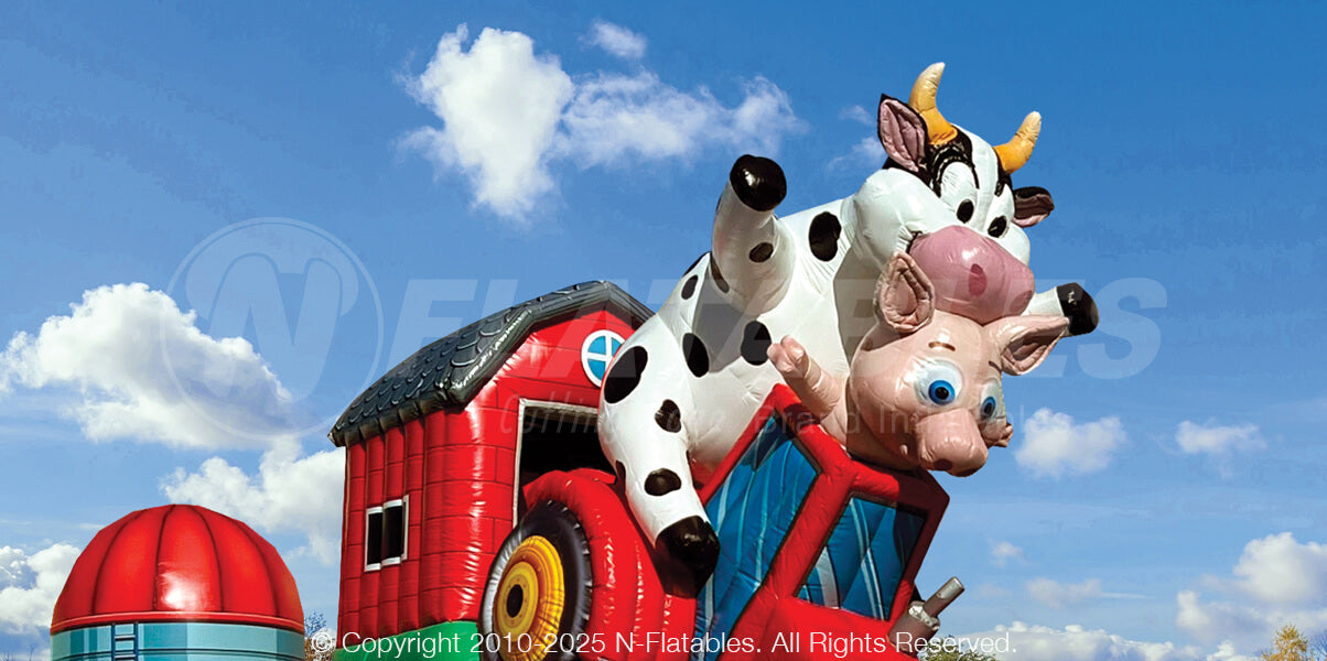 Closeup of inflatable cow and pig characters on the barnyard breakout obstacle course. 