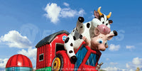 Closeup of inflatable cow and pig characters on the barnyard breakout obstacle course. 