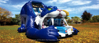 Giant blue sabretooth tiger inflatable slide set up in a park. 