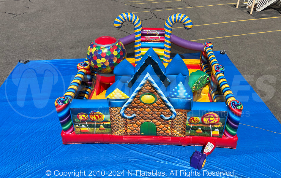 Back view of the Candy Playland™ inflatable toddler play area showing the gingerbread house artwork and inflatable gumball machine. 