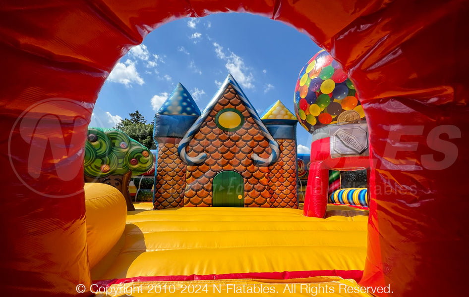 View through the entrance of the Candy Playland™ showing the inflatable ginger bread house and bouncing area. 