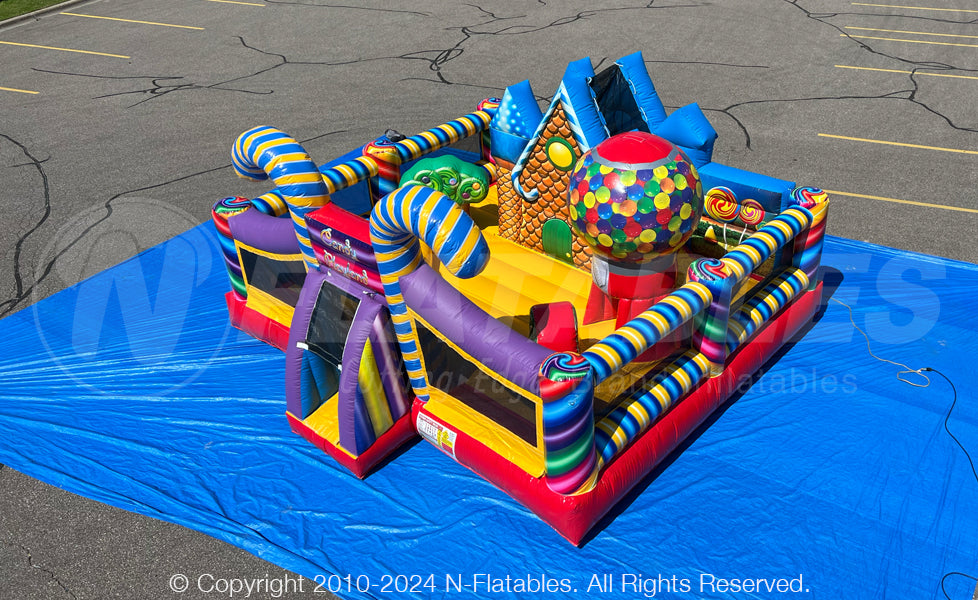 Aerial view of the Candy Playland™ inflatable toddler play area featuring a colorful bouncing area, slide, and candy themed popups.