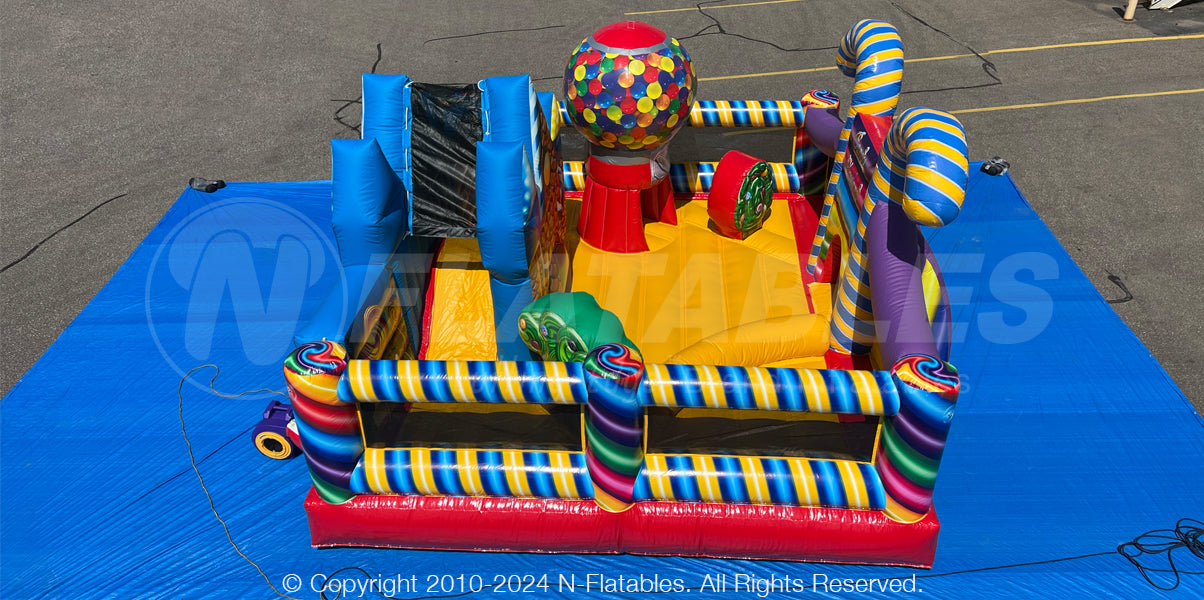 Aerial view of the Candy Playland™ showing the slide, bouncing area, and inflatable tunnel shaped like a gumball machine.