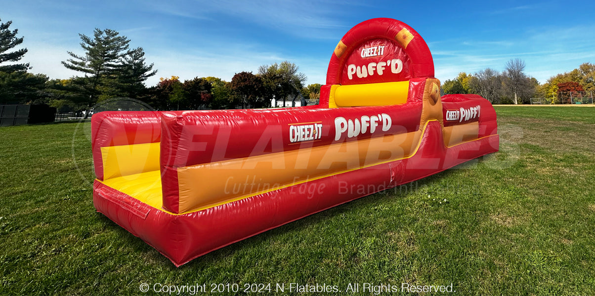 Cheez-It™ Puff'd branded Inflatable Obstacle Course set up in a park