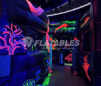 Inside of an ocean-themed inflatable blacklight reactive laser tag maze. 