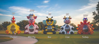Five large inflatable farm-themed inflatable bounce houses shaped like a chicken, pig, bee, cow, and turkey, displayed outdoors on a grassy lawn at sunset with height labels above each bouncer