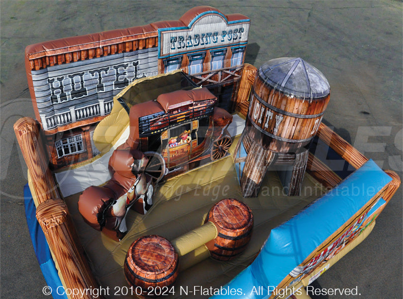 Overhead view of the inside of the Old West Playland™ inflatable play area with stagecoach themed slide, and bounce house. 