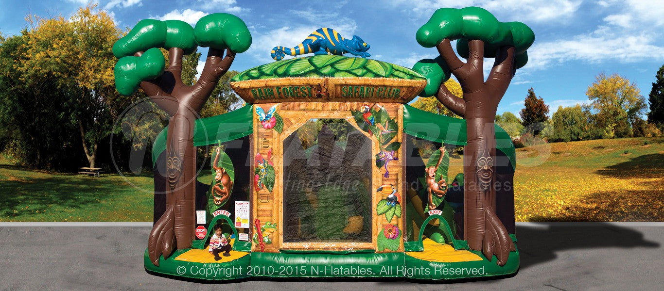 Front view of the Rainforest Fun Center™ combo decorated with inflatable jungle trees and a chameleon. 