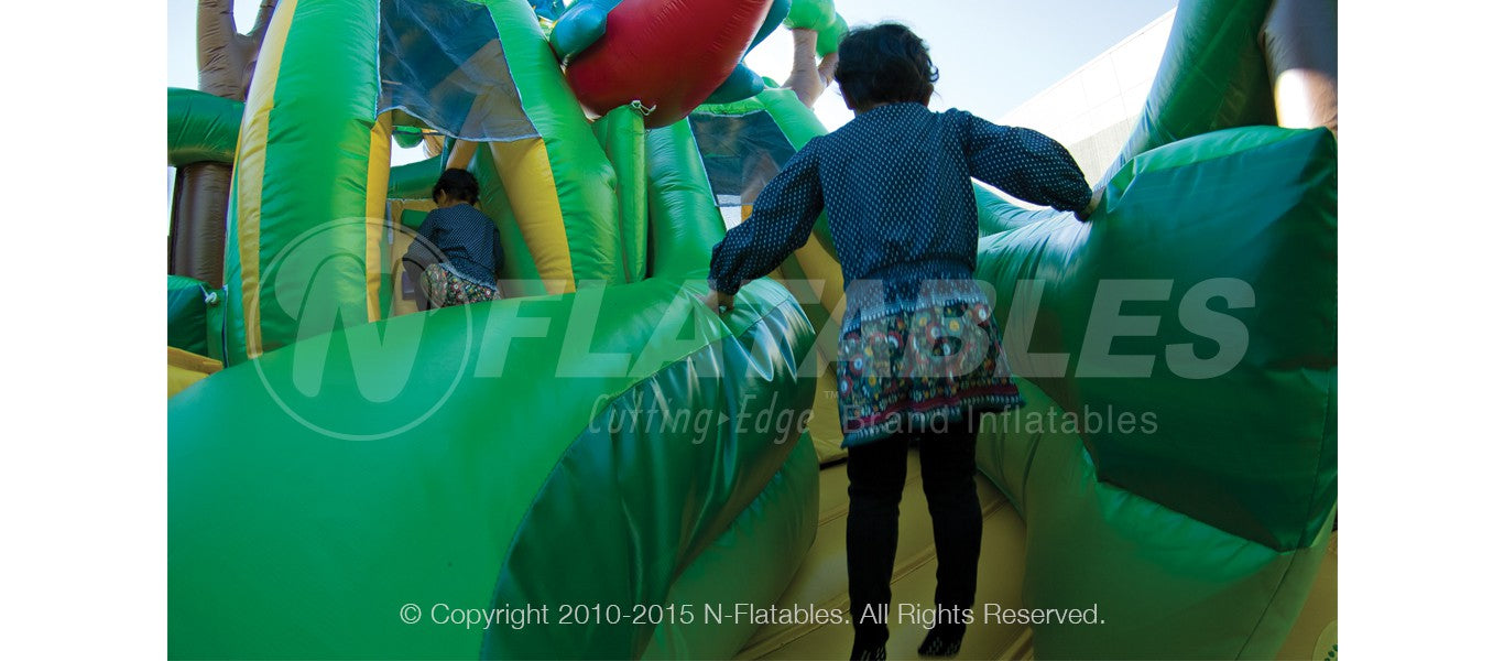 Kid running through the Rainforest Fun Center™ inflatable combo