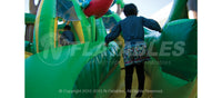 Kid running through the Rainforest Fun Center™ inflatable combo