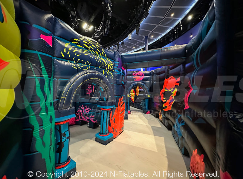 The inside of a custom blacklight-reactive inflatable maze with the blacklights off.  