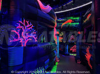 The interior of a custom modular blacklight reactive maze with colorful under the sea designs. 