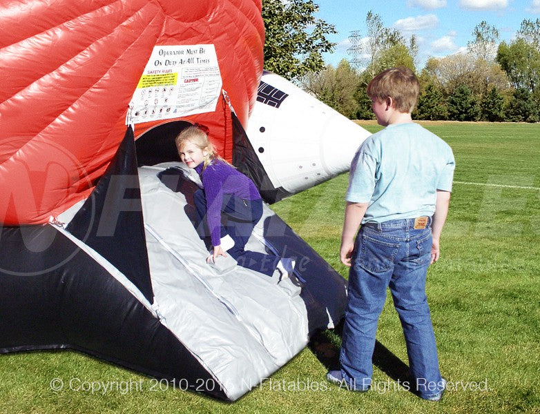 Two kids entering the Shuttle Play Space™ bounce house.