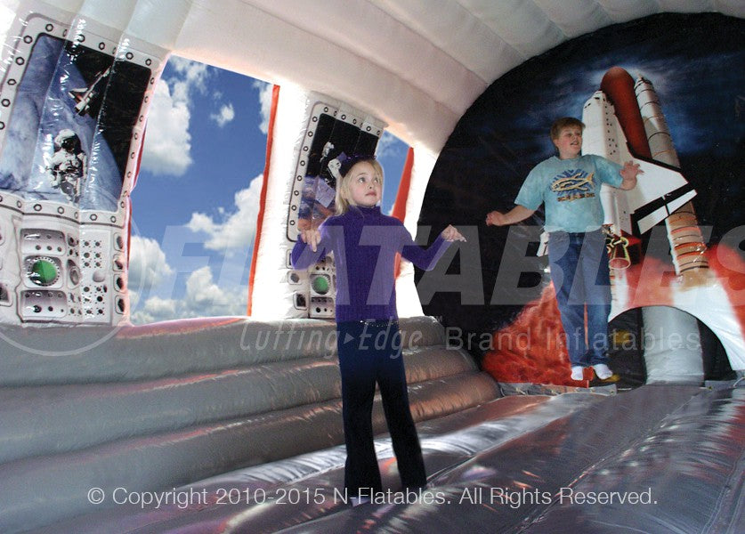 Two kids jumping inside the Shuttle Play Space™ bounce house