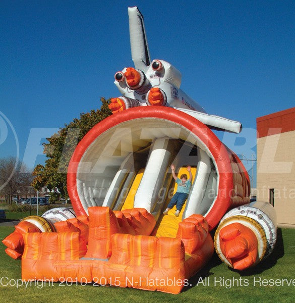 A kid sliding out the Shuttle Play Space™ bounce house combo. 