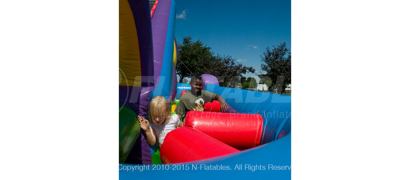 Kids running through the obstacles on the Wacky Slide Combo™ inflatable playground. 