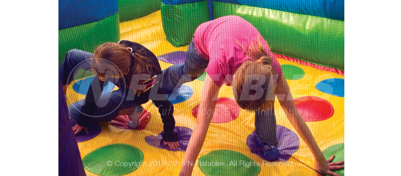 Two kids playing inside the bouncing area of the Wacky World inflatable combo 